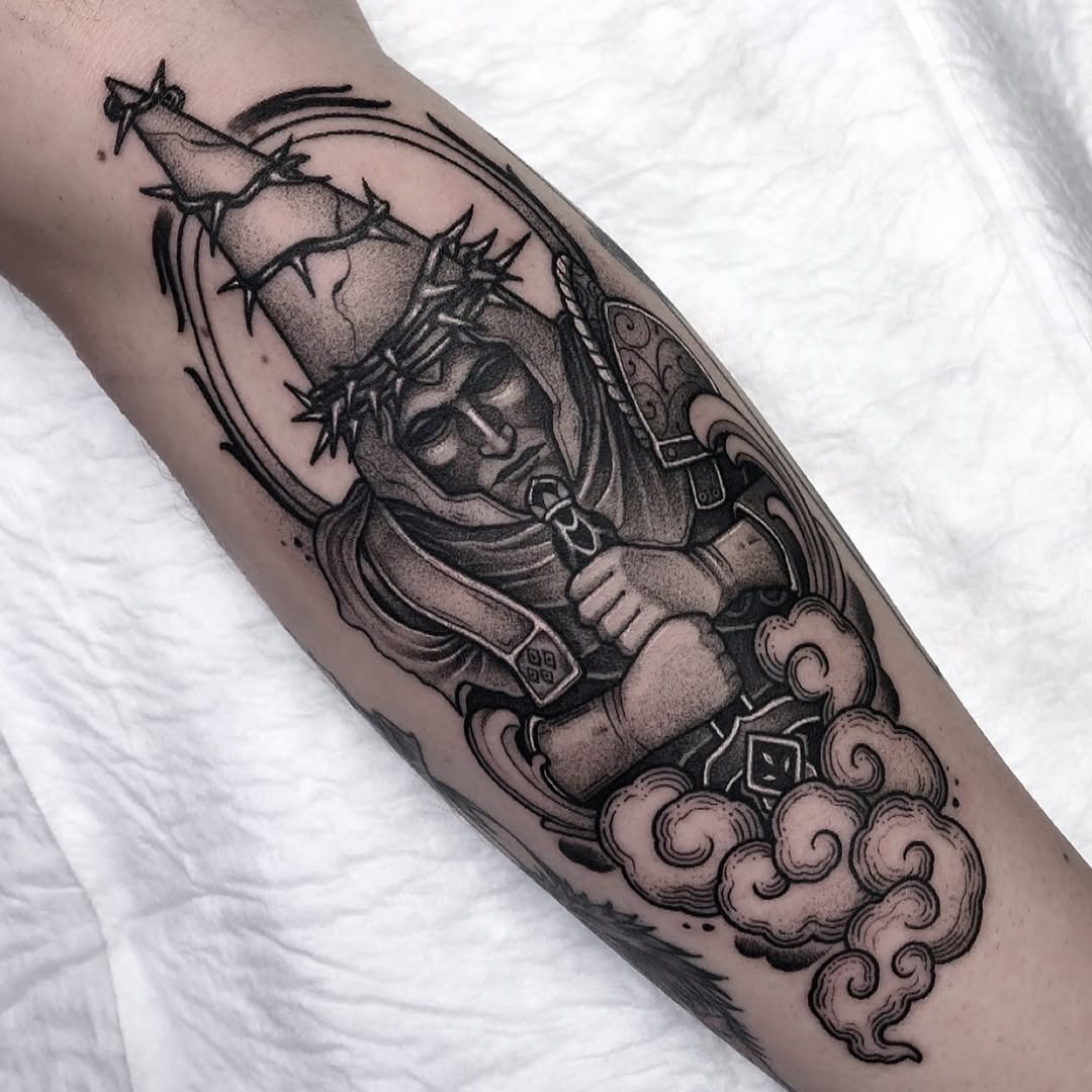 Black and grey tattoo of a warrior deity or demon figure with ornate armor, holding a spiked mace, seated on clouds on the forearm.