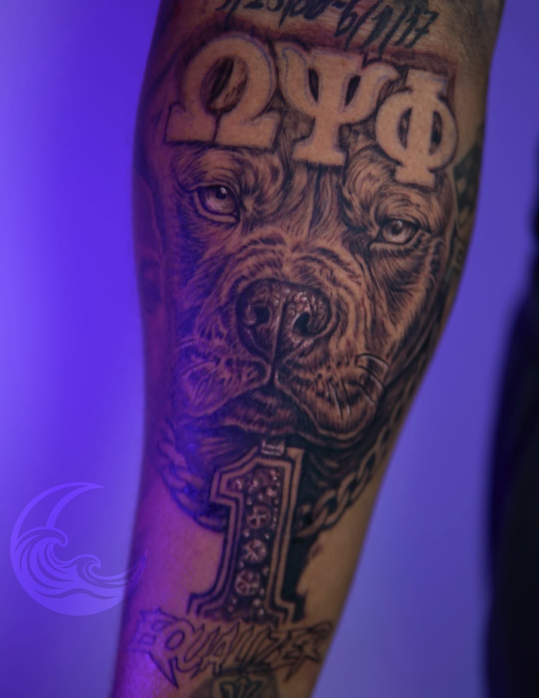 Three bearded male faces with ornate symbols above, detailed shading on forearm, black and grey ink.