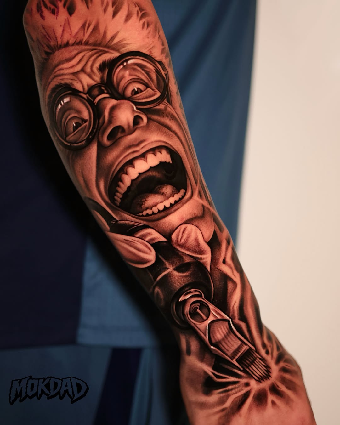 Expressive face with glasses and open mouth wearing bow tie, rendered in black and grey shading on forearm with small revolver below.