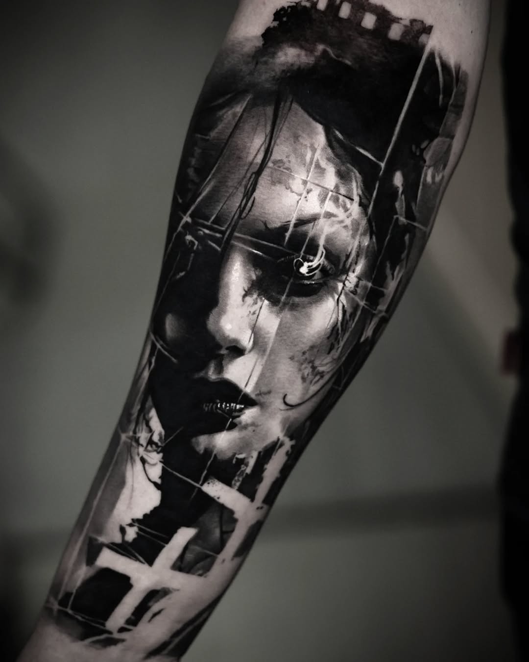Monochrome photorealistic portrait of a face with geometric line overlay on the forearm.