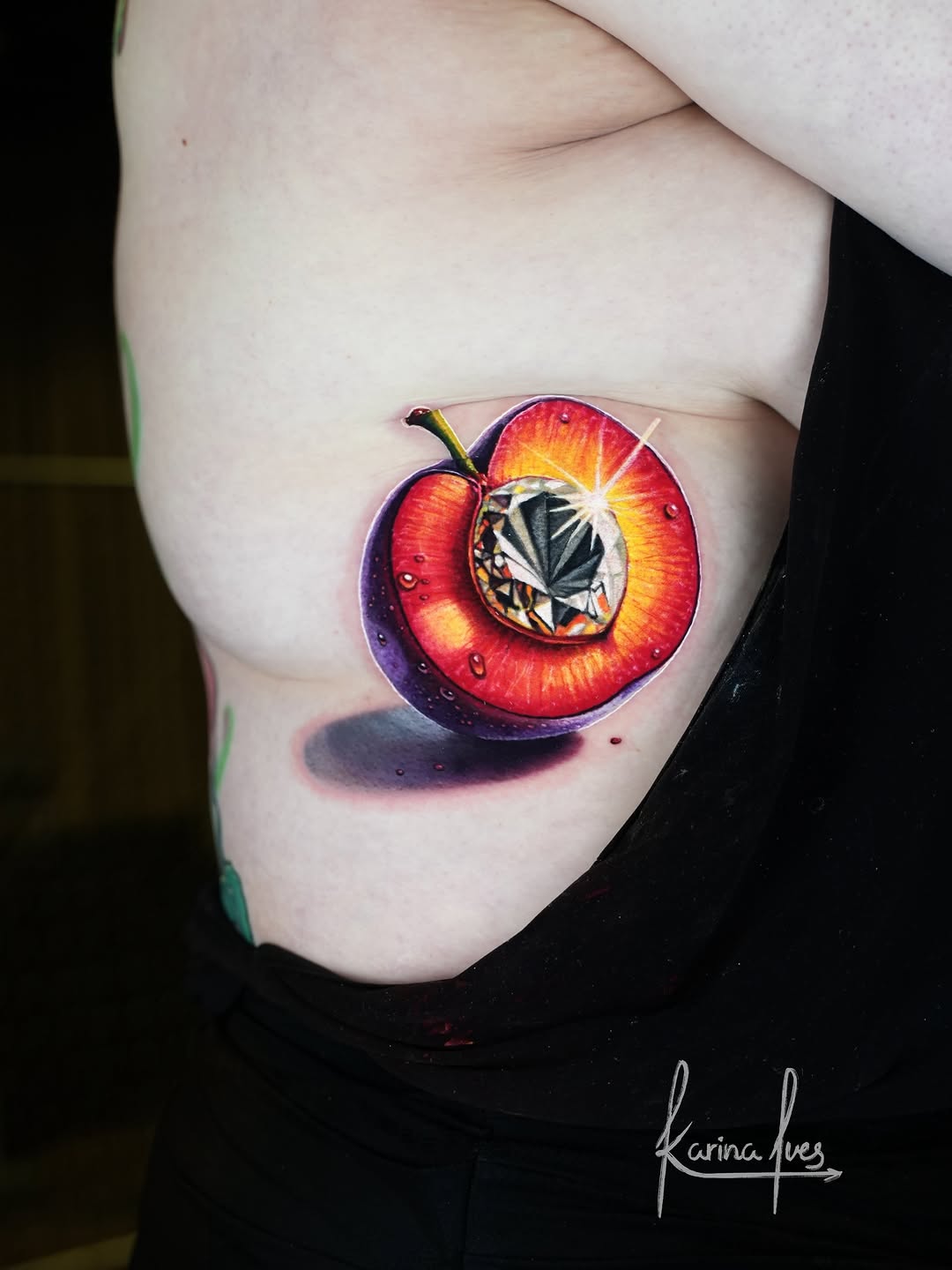 Three-dimensional red apple with internal geometric facets and glowing highlights, placed on upper arm.