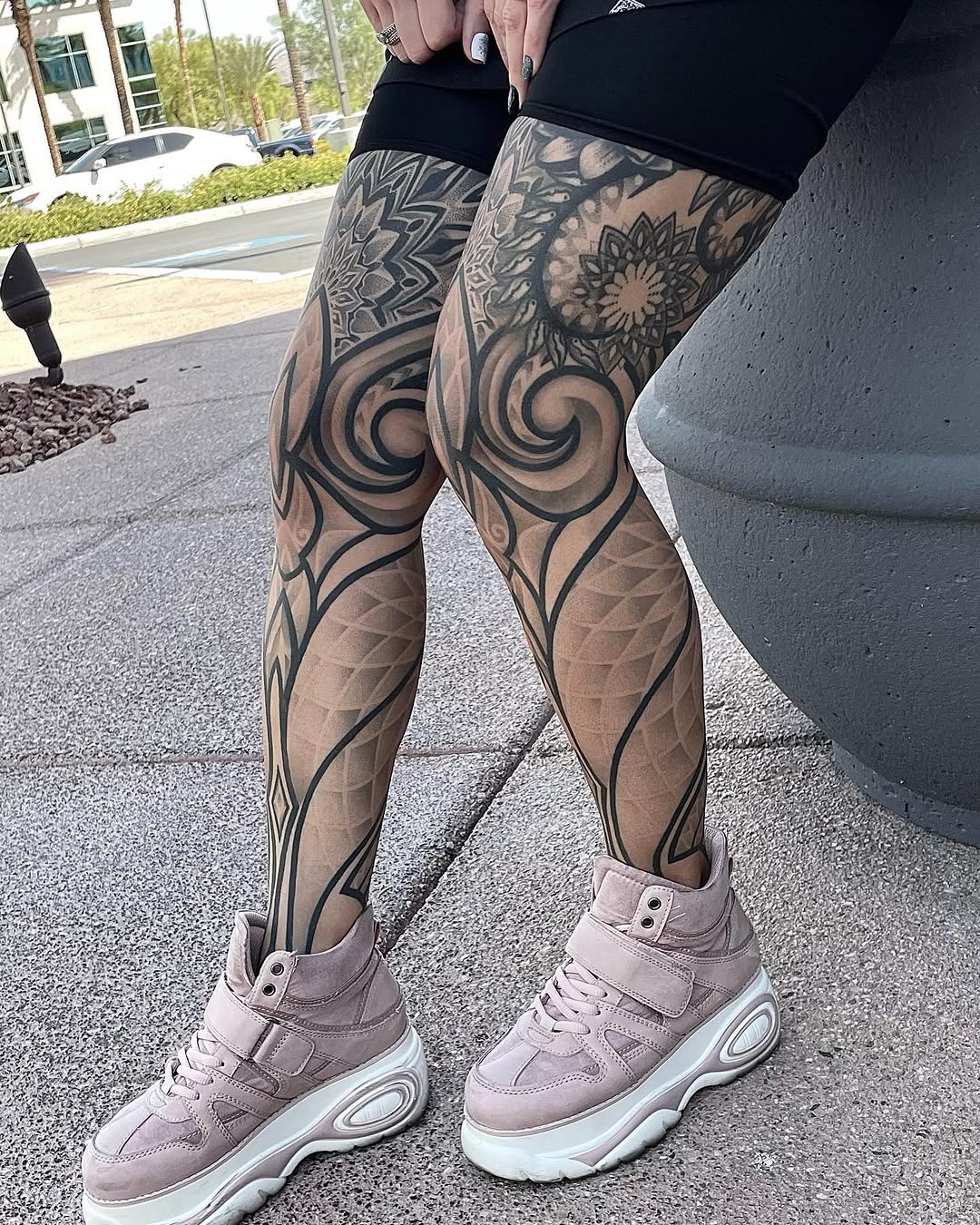 Full leg sleeve with mandala florals, ornamental swirls, and geometric linework in black ink from hip to ankle.