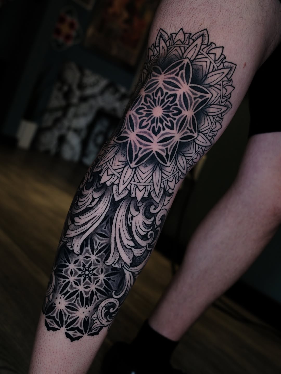 Ornamental mandala sleeve with intricate geometric snowflake patterns, symmetrical linework, and decorative baroque flourishes on forearm.